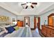 Bedroom featuring a trey ceiling, ceiling fan, hardwood floors and wooden dressers at 621 Thorne Dr, Brownsburg, IN 46112