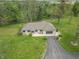 Expansive aerial view of a ranch-style home featuring a long driveway and large, well-manicured lawn at 6212 Rocklane Rd, Greenwood, IN 46143