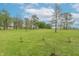 Expansive green backyard with scattered trees, offering a peaceful and private outdoor space, ready for recreation and relaxation at 6212 Rocklane Rd, Greenwood, IN 46143