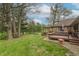 Expansive backyard featuring a deck, seating area, and lush greenery, ideal for outdoor relaxation and entertaining at 6212 Rocklane Rd, Greenwood, IN 46143