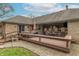 Backyard brick house boasts an expansive wooden deck with a comfortable seating area for relaxing and entertaining at 6212 Rocklane Rd, Greenwood, IN 46143