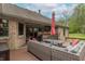 Backyard deck features a cozy seating area with an umbrella and a convenient bar with counter seating at 6212 Rocklane Rd, Greenwood, IN 46143