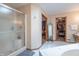 Bathroom with a glass-enclosed shower, a whirlpool tub, and a view into the main bedroom and walk-in closet at 6212 Rocklane Rd, Greenwood, IN 46143