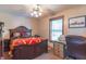 Cozy bedroom featuring a decorative bed frame, ceiling fan, and natural light from the window at 6212 Rocklane Rd, Greenwood, IN 46143