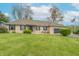 Charming brick ranch-style home with blue shutters, attached garage, and lush green lawn at 6212 Rocklane Rd, Greenwood, IN 46143