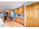 Well-lit kitchen with stainless steel refrigerator, wood cabinets, and tile flooring at 6212 Rocklane Rd, Greenwood, IN 46143