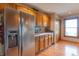 Contemporary kitchen featuring stainless steel appliances, wood cabinets, and adjacent storage at 6212 Rocklane Rd, Greenwood, IN 46143