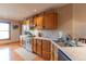 Functional kitchen with ample counter space, white appliances, and wood cabinetry at 6212 Rocklane Rd, Greenwood, IN 46143