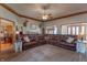 Large living room with sectional sofa, ceiling fan, crown molding, and natural light at 6212 Rocklane Rd, Greenwood, IN 46143
