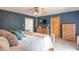Spacious main bedroom with a wooden bed frame, a view of the bathroom, and bright, natural light at 6212 Rocklane Rd, Greenwood, IN 46143