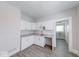 Functional kitchen with white cabinetry, granite counters, and gray wood-look floors at 625 Arbor Ave, Indianapolis, IN 46221