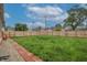 Large grassy backyard with a new wood fence and a red brick border, creating a private outdoor space at 625 Maple St, Columbus, IN 47201