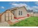 Nice backyard featuring a storage shed, red painted foundation and a partial red brick border at 625 Maple St, Columbus, IN 47201