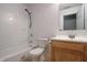 Standard bathroom with a shower-tub combo, toilet, and a wooden vanity with sink and a mirror at 625 Maple St, Columbus, IN 47201