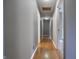 Long hallway featuring hardwood floors, neutral color walls, and recessed lighting at 625 Maple St, Columbus, IN 47201