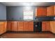 An updated kitchen area featuring wooden cabinets and black appliances at 625 Maple St, Columbus, IN 47201