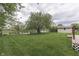Expansive backyard with mature tree, shed, and partial lake view, perfect for outdoor enjoyment at 6337 Whitaker Farms Dr, Indianapolis, IN 46237