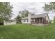 View of the backyard featuring a deck, storage shed, and lush green lawn, offering ample outdoor space at 6337 Whitaker Farms Dr, Indianapolis, IN 46237