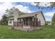 Home exterior featuring a deck, screened in porch, and lush green grass at 6337 Whitaker Farms Dr, Indianapolis, IN 46237