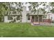 Home exterior featuring a deck, screened in porch, and lush green grass at 6337 Whitaker Farms Dr, Indianapolis, IN 46237