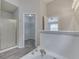 Bathroom with a large vanity, tiled tub surround, and doorways to a closet and bedroom at 6337 Whitaker Farms Dr, Indianapolis, IN 46237