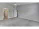Large bedroom with ceiling fan, neutral carpet, and doorways to the closet and bathroom at 6337 Whitaker Farms Dr, Indianapolis, IN 46237