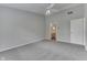 Large bedroom with ceiling fan, neutral carpet, and doorway to the bathroom with dual sink vanity at 6337 Whitaker Farms Dr, Indianapolis, IN 46237