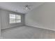 Bright bedroom featuring neutral carpet, ample natural light from the large window, and a modern ceiling fan at 6337 Whitaker Farms Dr, Indianapolis, IN 46237