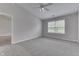 Spacious bedroom showcasing neutral carpet, a ceiling fan, and natural light from the window at 6337 Whitaker Farms Dr, Indianapolis, IN 46237