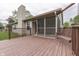 A view of a home's deck, complete with a screened-in porch and charming wooden swing at 6337 Whitaker Farms Dr, Indianapolis, IN 46237