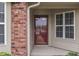 Close-up view of the front door and surrounding brick and siding details at 6337 Whitaker Farms Dr, Indianapolis, IN 46237