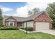 Charming single-story home with brick accents, a well-manicured lawn, and an attached two-car garage at 6337 Whitaker Farms Dr, Indianapolis, IN 46237