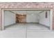 Garage view highlighting concrete floor, cabinets, and door to the house at 6337 Whitaker Farms Dr, Indianapolis, IN 46237