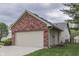 View of the side of the home showcasing a two-car garage and the exterior siding material at 6337 Whitaker Farms Dr, Indianapolis, IN 46237