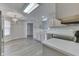 Well-lit kitchen features modern appliances, light wood cabinets, white countertops, and open dining area with chandelier at 6337 Whitaker Farms Dr, Indianapolis, IN 46237