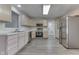 Modern kitchen features stainless steel appliances, neutral cabinets, and gray wood flooring at 6337 Whitaker Farms Dr, Indianapolis, IN 46237