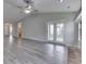 Expansive living room showcasing the vaulted ceiling and view to a patio through a glass door at 6337 Whitaker Farms Dr, Indianapolis, IN 46237