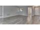 Bright living room showcases gray walls, lovely gray wood flooring, and an open layout at 6337 Whitaker Farms Dr, Indianapolis, IN 46237
