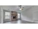 Bright living room featuring a brick fireplace, vaulted ceiling, and two large windows for natural light at 6337 Whitaker Farms Dr, Indianapolis, IN 46237