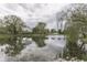 Picturesque view of a tranquil pond surrounded by lush trees, enhancing the property's serene ambiance at 6337 Whitaker Farms Dr, Indianapolis, IN 46237