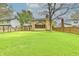 Manicured backyard features mature trees, shed, wooden fence, and a screened in back porch at 6352 Watercrest Way, Indianapolis, IN 46278