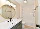 Freshly updated bathroom with modern vanity, round mirror, and shower and bathtub combo at 6352 Watercrest Way, Indianapolis, IN 46278