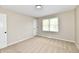 Neutral bedroom with carpet and a window and a door in the corner at 6352 Watercrest Way, Indianapolis, IN 46278