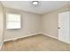 Bedroom with carpet, neutral-toned walls, one window and a white door on the right at 6352 Watercrest Way, Indianapolis, IN 46278