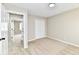 Bedroom featuring neutral walls, carpet, a walk-in closet and view of a hallway through the doorway at 6352 Watercrest Way, Indianapolis, IN 46278
