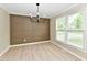 Open dining room featuring neutral walls, modern lighting, and a large window for natural light at 6352 Watercrest Way, Indianapolis, IN 46278