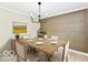 Dining room set, ready for hosting and entertaining, with modern light fixture above at 6352 Watercrest Way, Indianapolis, IN 46278