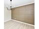 Bright dining room showcasing modern lighting, a wainscoted accent wall, and fresh flooring at 6352 Watercrest Way, Indianapolis, IN 46278