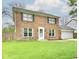 Charming two-story brick home with a well-maintained lawn and attached two-car garage at 6352 Watercrest Way, Indianapolis, IN 46278