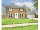 Charming two story brick home with attached two car garage and luscious green yard at 6352 Watercrest Way, Indianapolis, IN 46278